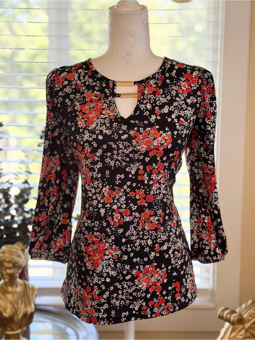 Black Floral Keyhole Blouse with Red Accents and Gold Bar
